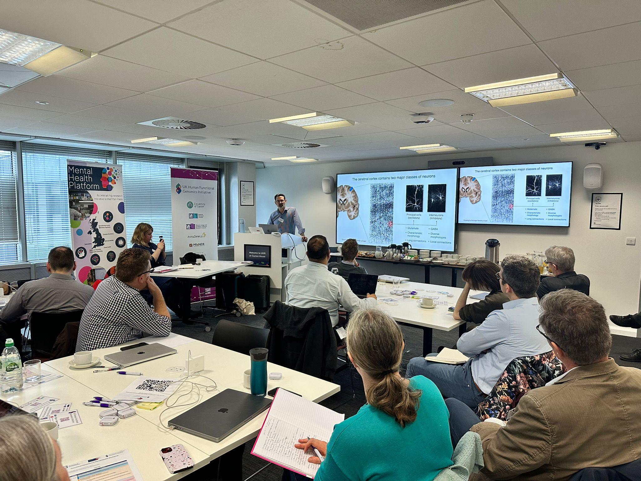 researchers in room watching talks