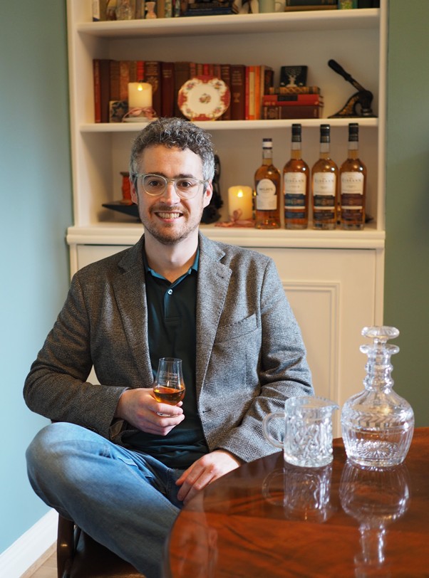 sam holding whisky glass