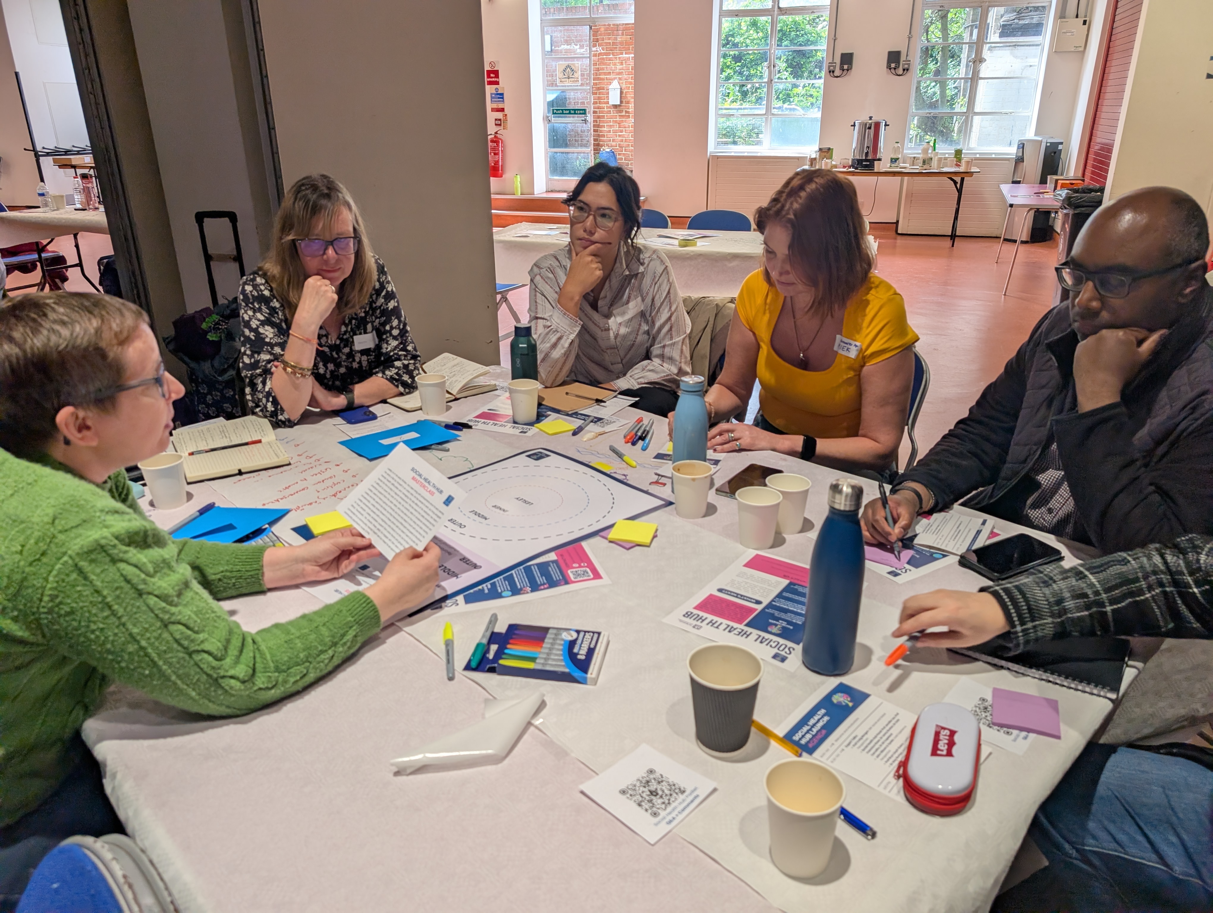 Social Health Hub Launch room people talking around table