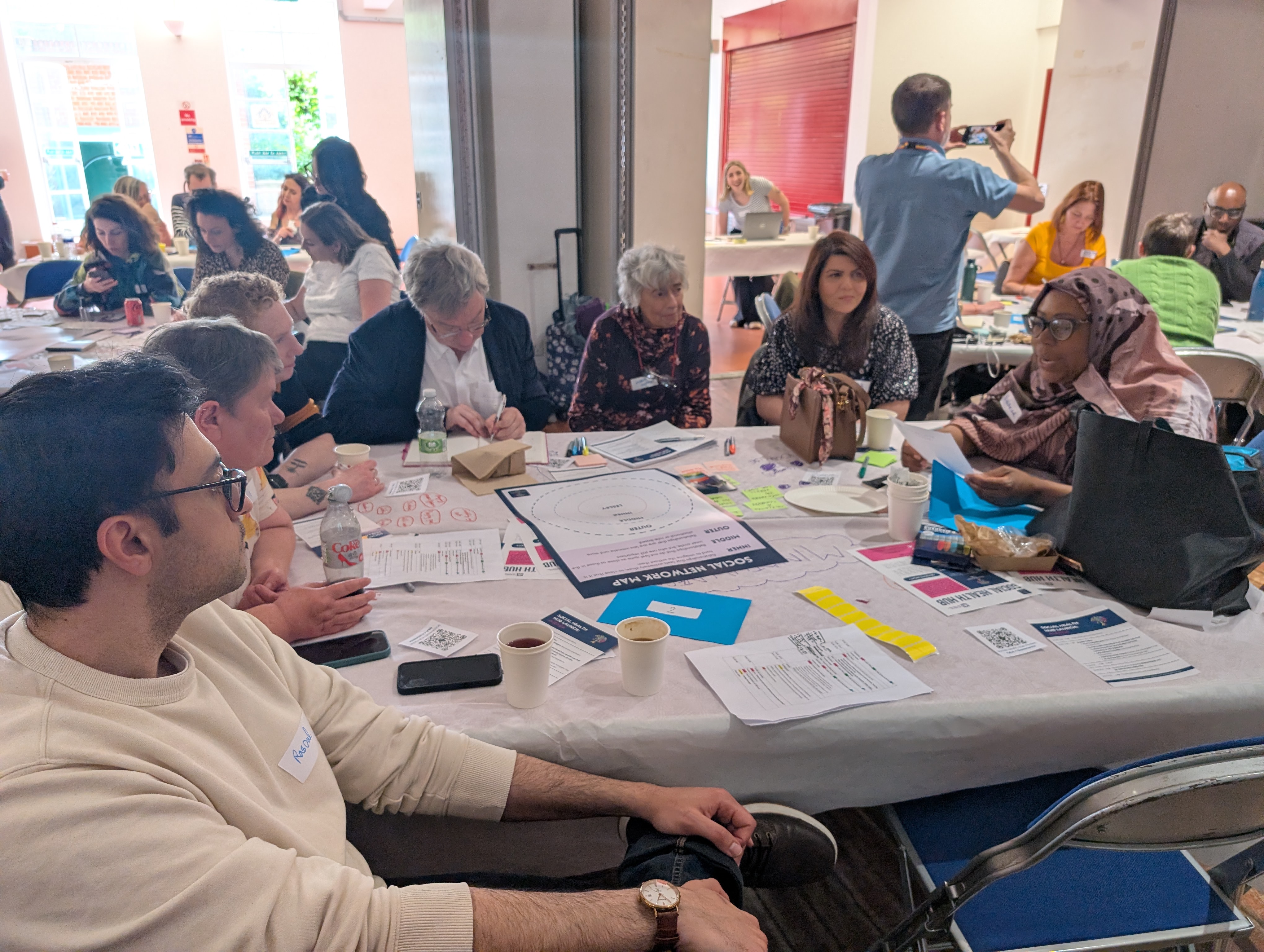 Social Health Hub Launch room table people talking