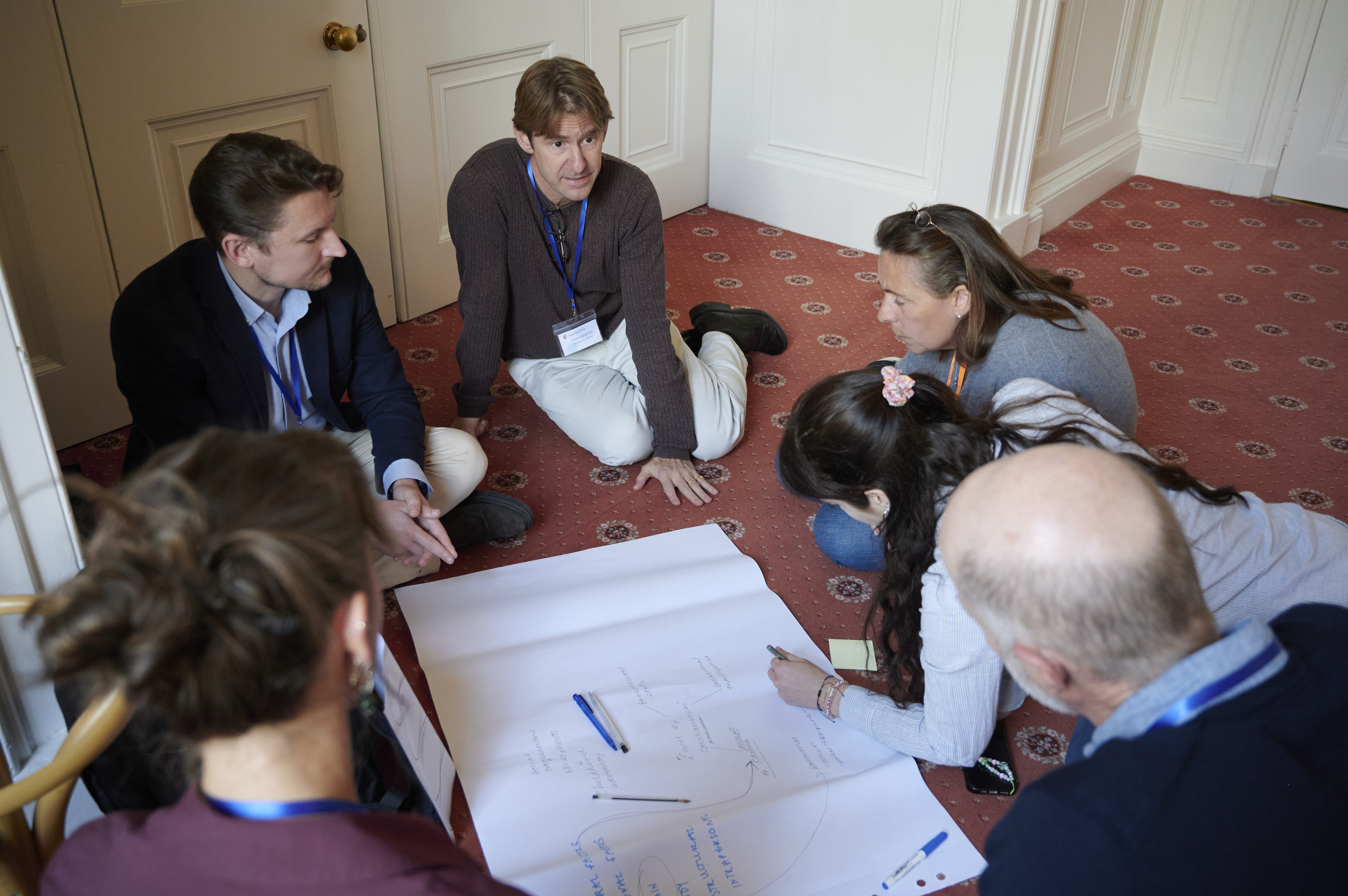 people sitting on floor and talking