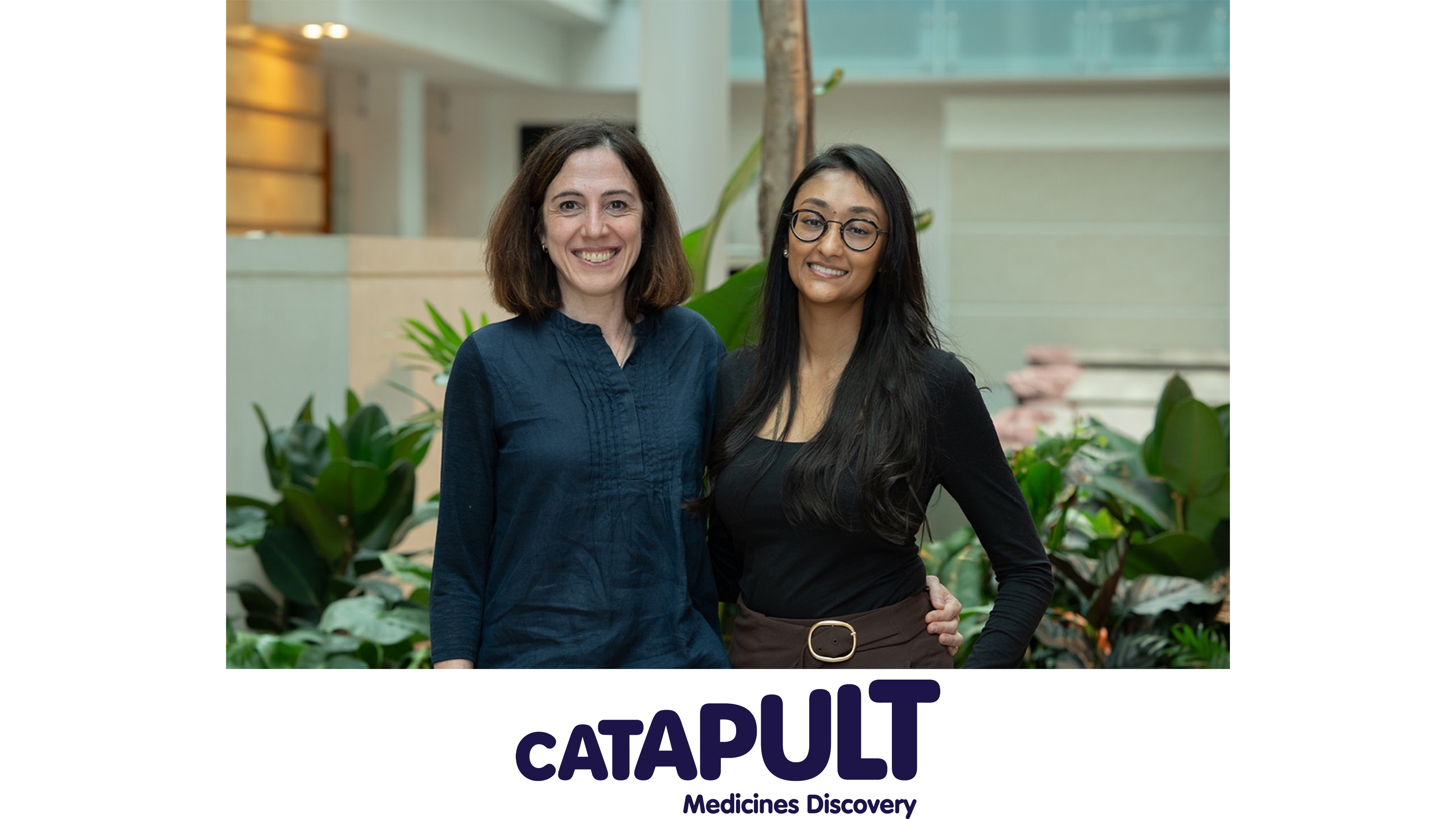 Sara and Ekta from MDC standing in front of plant